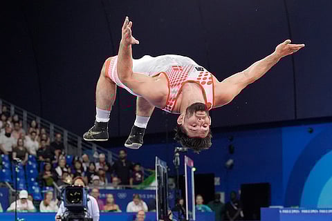 Denmark's Turpal-Ali Bisultanov celebrates after men's Greco-Roman 87kg bronze medal wrestling match